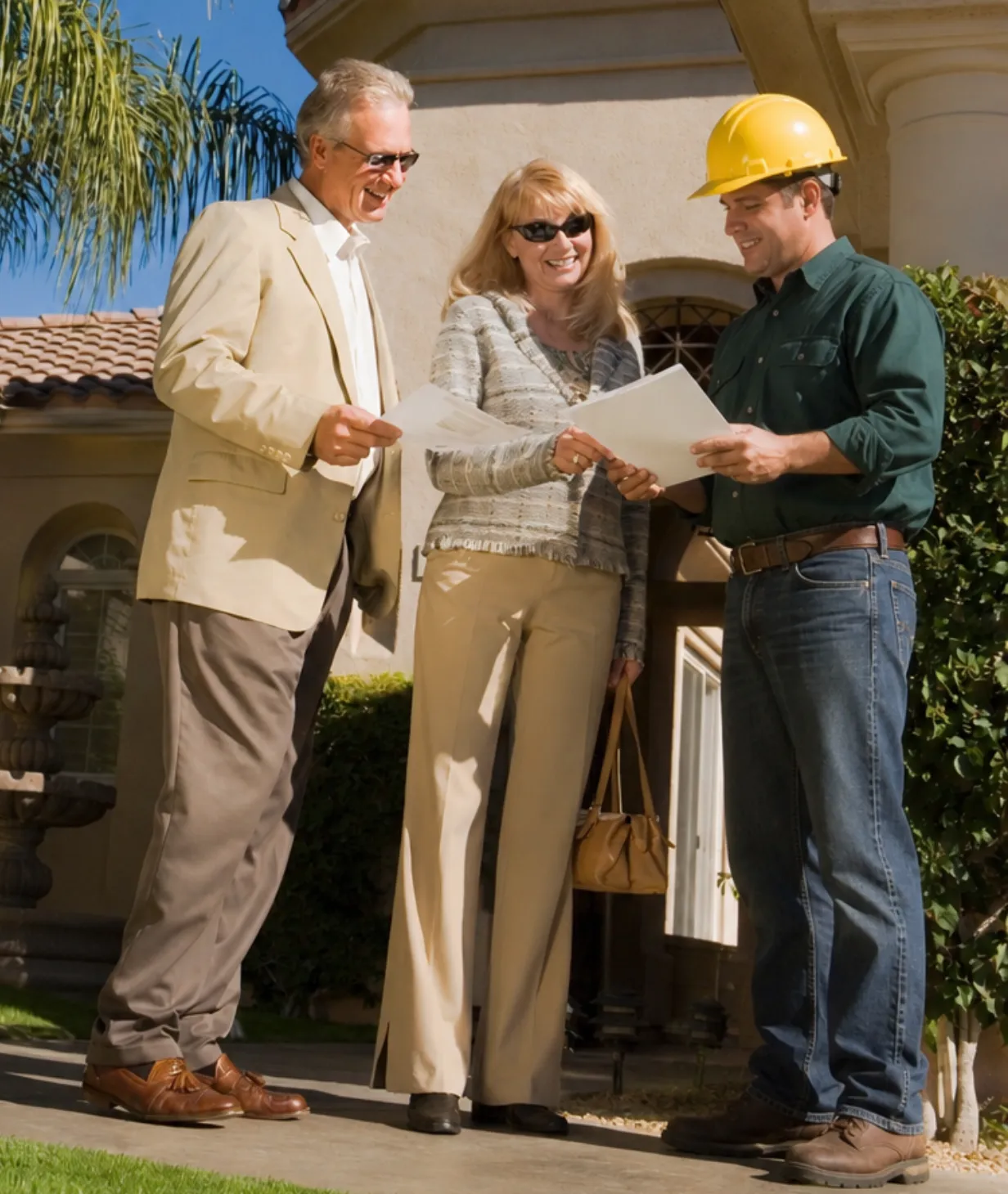 Contractor reviewing construction plans with homeowners in Los Angeles