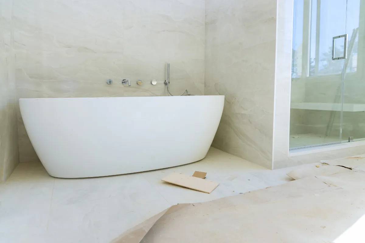 Bathroom remodeling project in Los Angeles with freestanding tub, large-format wall tile, and glass shower installation