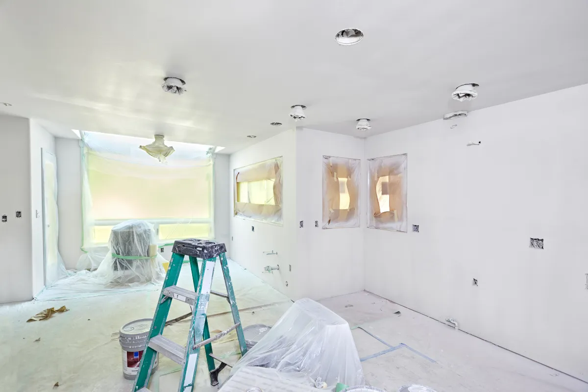 Home remodeling project in Los Angeles with interior walls, protected windows, painting prep, and renovation work in progress