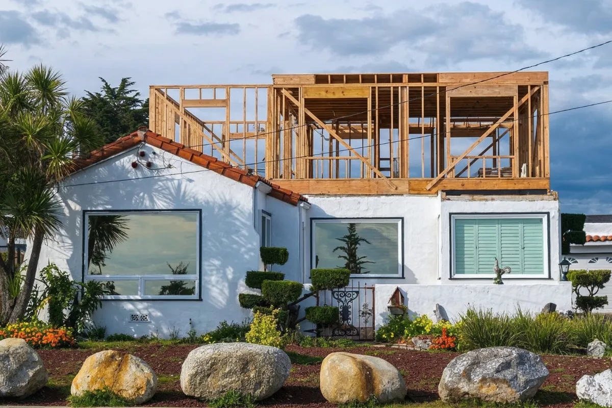 Room addition contractor in Los Angeles building a second-story home addition with new wood framing above an existing house